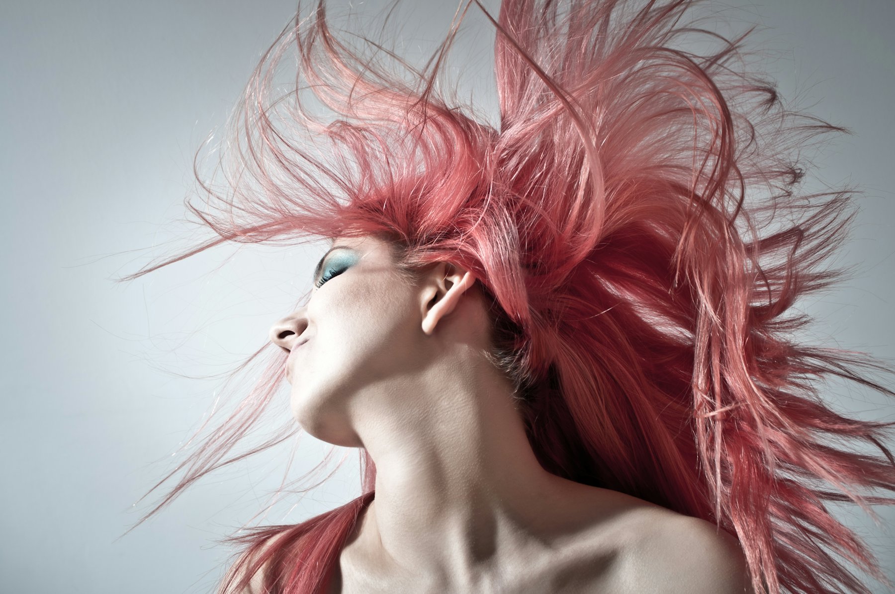 Woman flicking bright pink hair